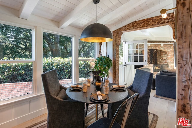 sunroom featuring plenty of natural light, lofted ceiling with beams, and wooden ceiling