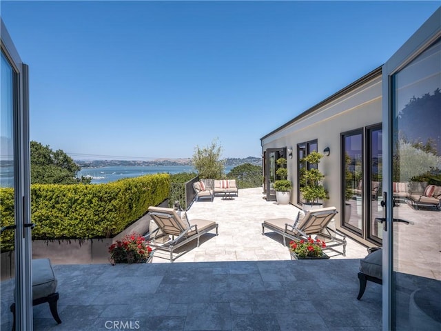 view of patio featuring a water view and an outdoor hangout area