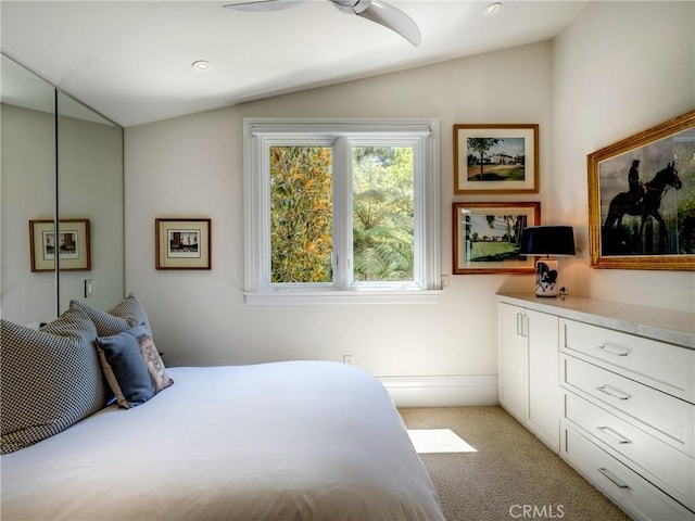 bedroom with light carpet, ceiling fan, and lofted ceiling