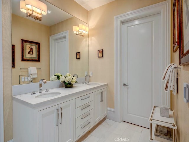 bathroom with tile patterned flooring, a notable chandelier, and vanity