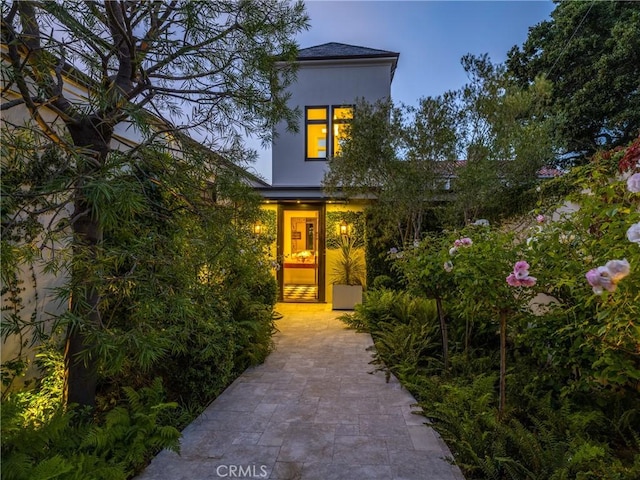 view of exterior entry at dusk