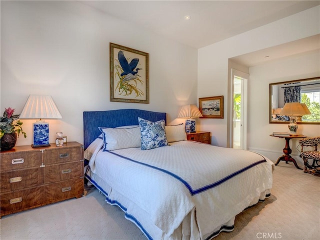 bedroom with light colored carpet