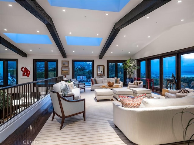 living room with vaulted ceiling with skylight and light hardwood / wood-style floors