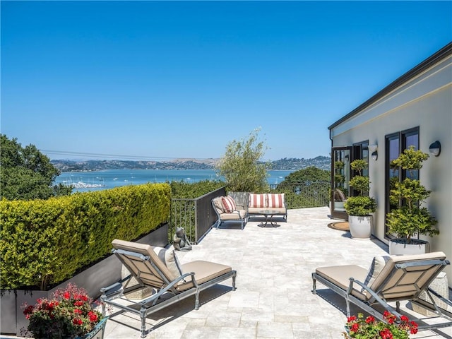 view of patio / terrace with outdoor lounge area and a water view