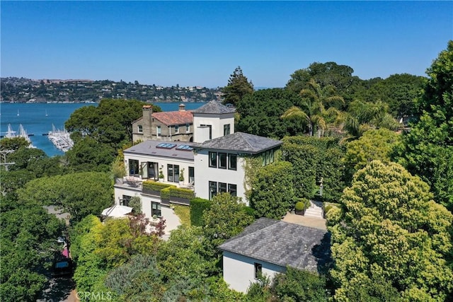 birds eye view of property with a water view