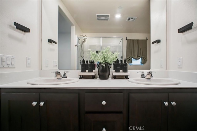 bathroom featuring vanity and a shower with door