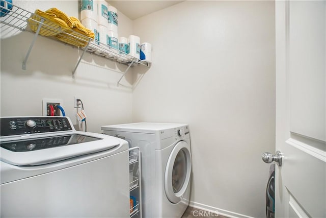 laundry room featuring washer and dryer and dark wood-type flooring