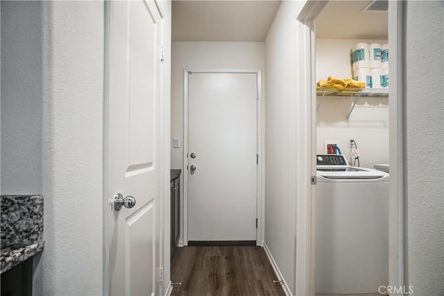 hallway with dark hardwood / wood-style flooring and washer / dryer