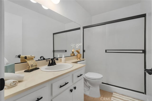 bathroom featuring vanity, hardwood / wood-style flooring, toilet, and a shower with door