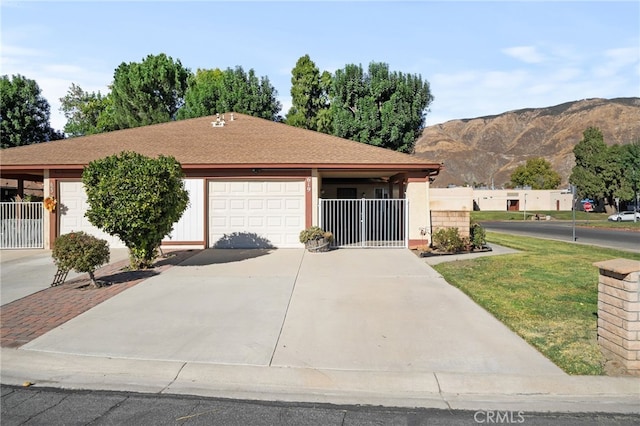 single story home featuring a mountain view and a garage