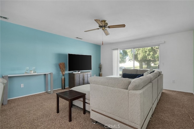 living room featuring ceiling fan and carpet