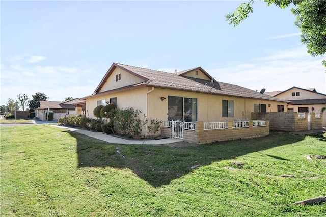 rear view of property featuring a yard