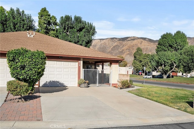 ranch-style home with a mountain view and a garage