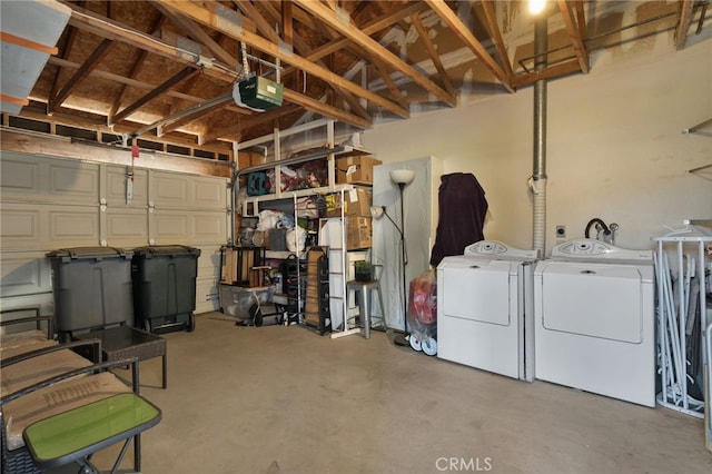 garage featuring washing machine and dryer and a garage door opener