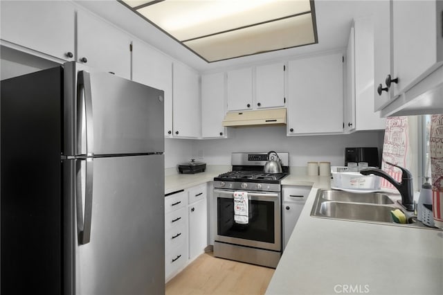 kitchen featuring white cabinetry, sink, appliances with stainless steel finishes, and light hardwood / wood-style flooring