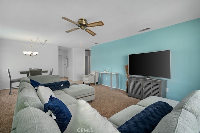 carpeted living room featuring ceiling fan with notable chandelier