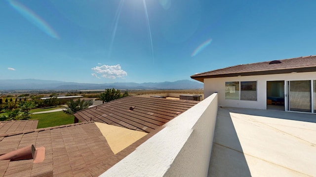 view of patio / terrace with a mountain view and a balcony