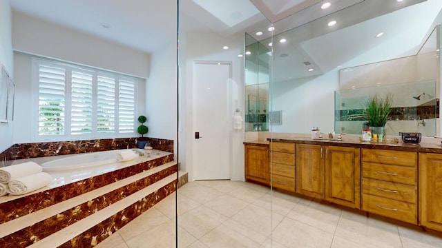 bathroom featuring tile patterned flooring, vanity, and plus walk in shower