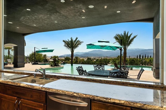 view of patio / terrace featuring a mountain view and sink