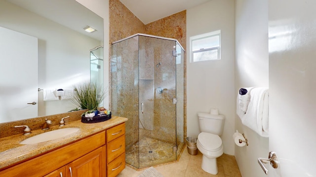 bathroom with vanity, toilet, tile patterned flooring, and walk in shower