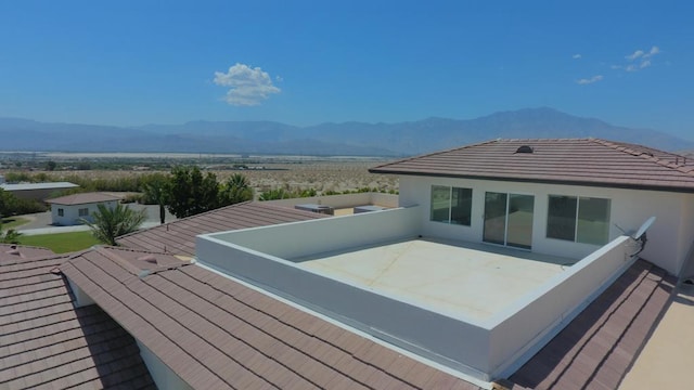 exterior space with a mountain view and a balcony