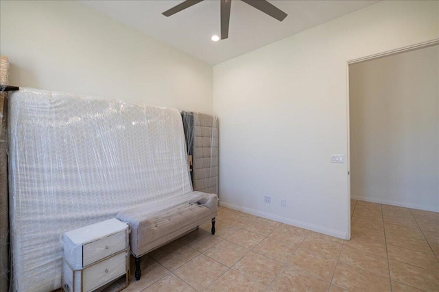 sitting room with ceiling fan and light tile patterned flooring