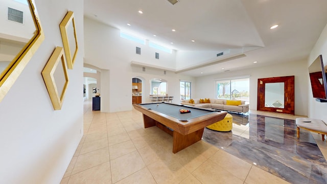 recreation room featuring light tile patterned flooring, a high ceiling, and pool table