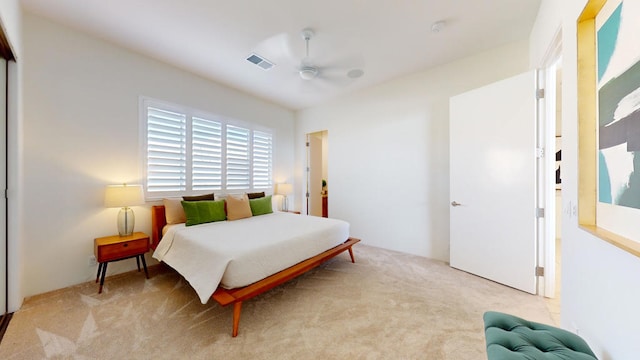 bedroom with ceiling fan and light colored carpet