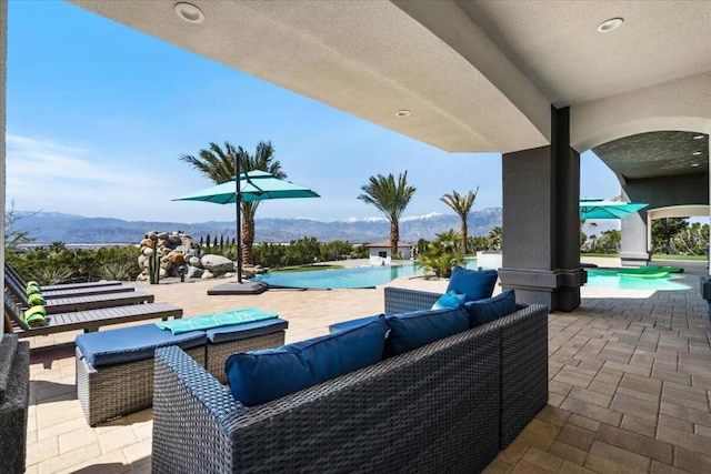 view of patio with a mountain view and an outdoor hangout area