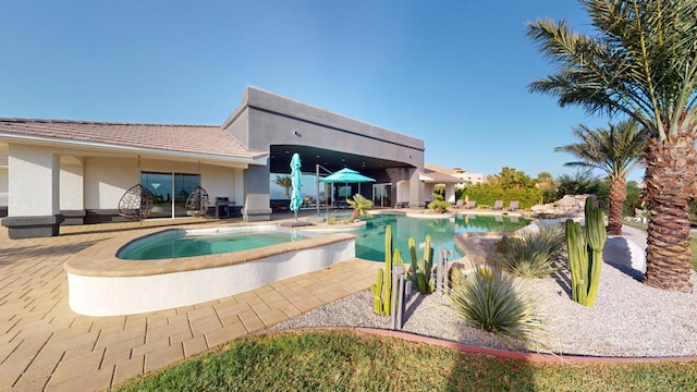 view of pool featuring an in ground hot tub and a patio