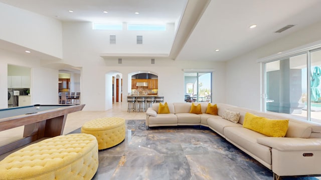 living room featuring washer / dryer and billiards