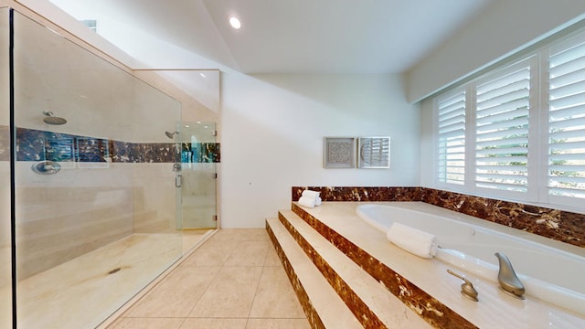 bathroom with shower with separate bathtub and tile patterned floors