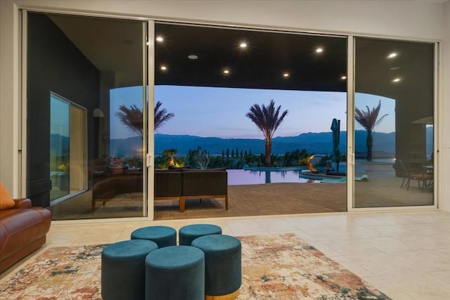 doorway featuring tile patterned floors and a mountain view