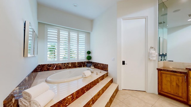 bathroom featuring tile patterned flooring, vanity, and a bathing tub