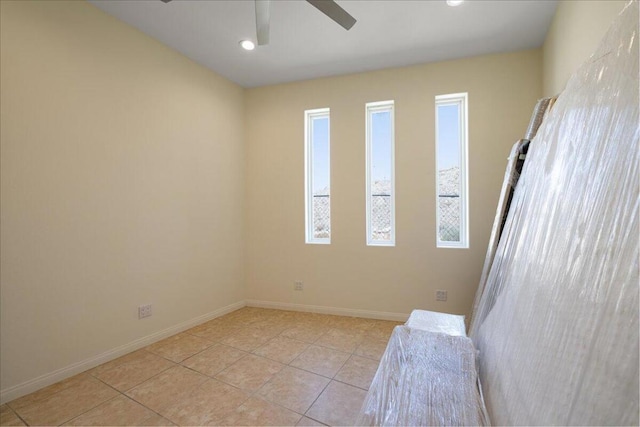 spare room featuring ceiling fan and light tile patterned floors