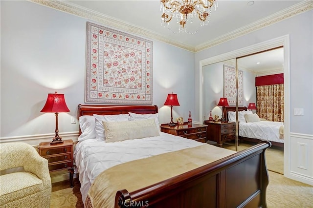 bedroom featuring a closet, an inviting chandelier, and ornamental molding