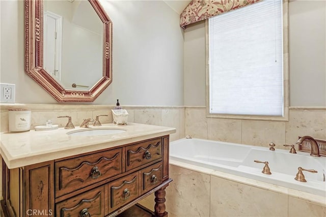 bathroom with vanity, a relaxing tiled tub, and vaulted ceiling