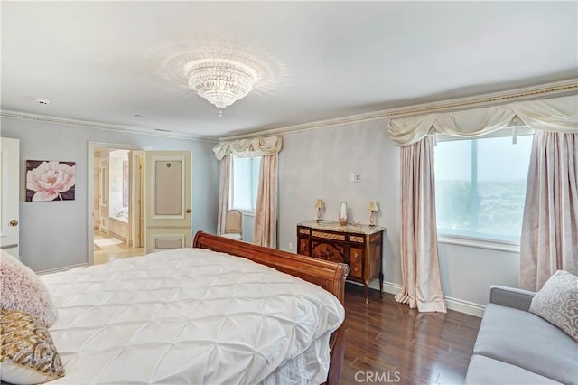 bedroom featuring hardwood / wood-style floors, ornamental molding, connected bathroom, and a chandelier