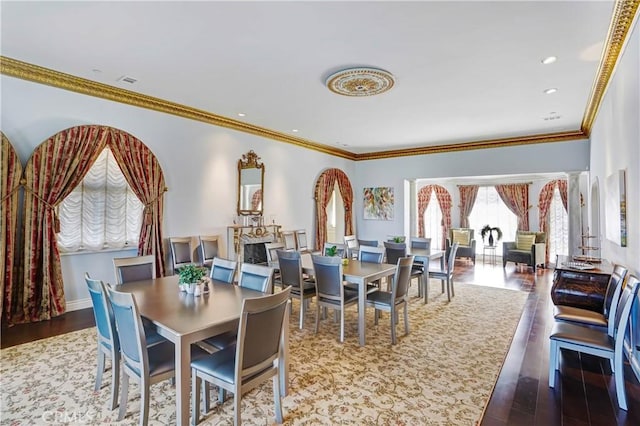 dining room featuring hardwood / wood-style flooring and crown molding