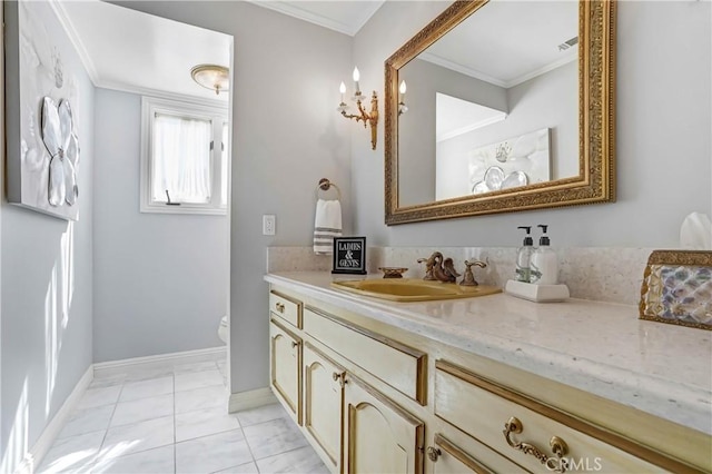 bathroom with toilet, vanity, tile patterned floors, and crown molding