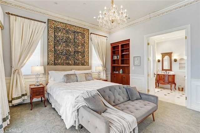 carpeted bedroom featuring ensuite bath, crown molding, sink, and an inviting chandelier