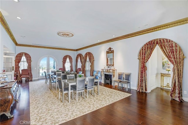 dining space with ornamental molding and dark wood-type flooring