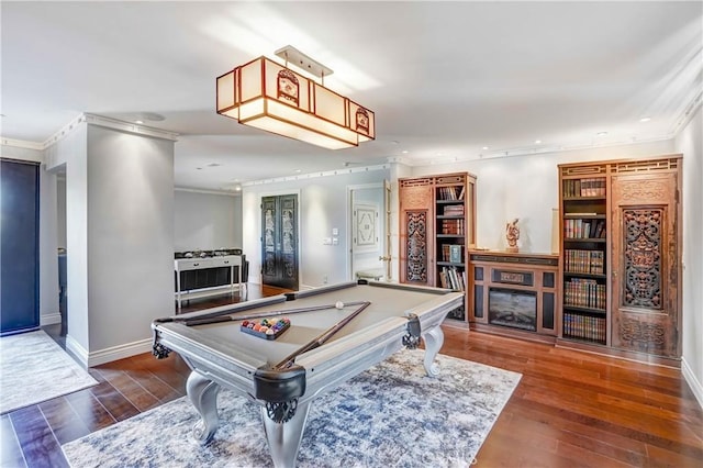 game room featuring dark hardwood / wood-style flooring, crown molding, and billiards