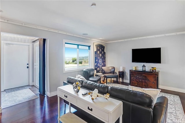 living room with dark wood-type flooring and ornamental molding