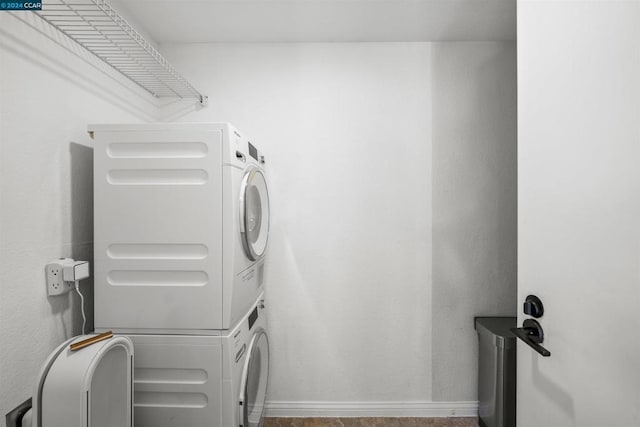 laundry room with stacked washing maching and dryer