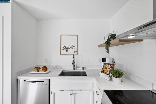 kitchen featuring dishwasher, light stone counters, white cabinetry, and sink