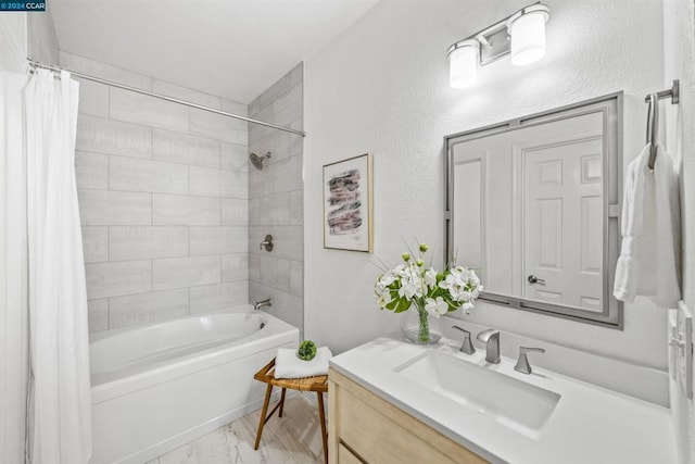 bathroom featuring shower / bath combo and vanity