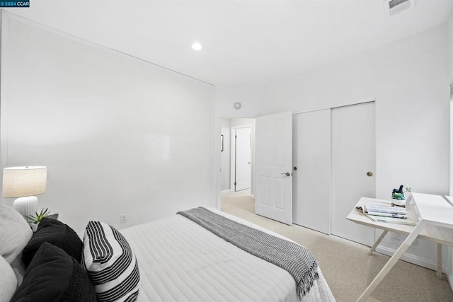 carpeted bedroom with a closet