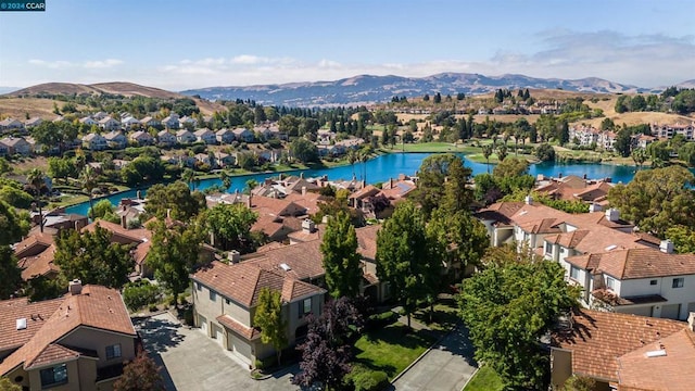 birds eye view of property featuring a water and mountain view