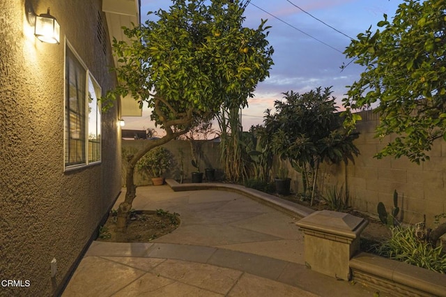 view of patio terrace at dusk